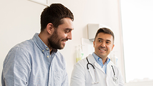 man speaking with male doctor
