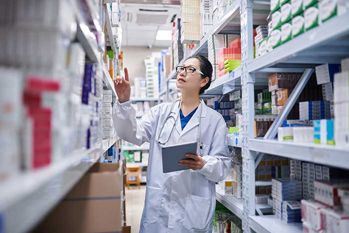 browse by category image of a pharmacy worker looking at shelves