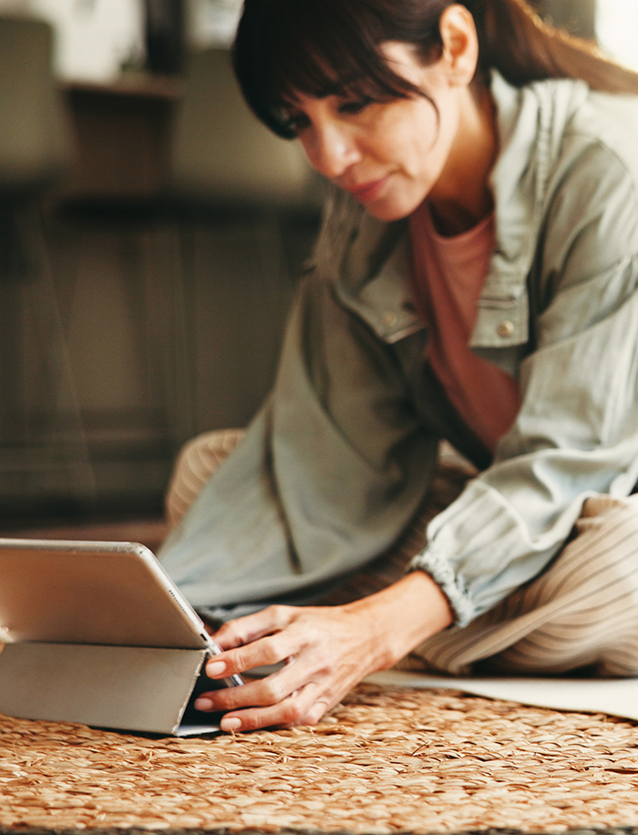 perimenopause symptoms woman sitting with ipad