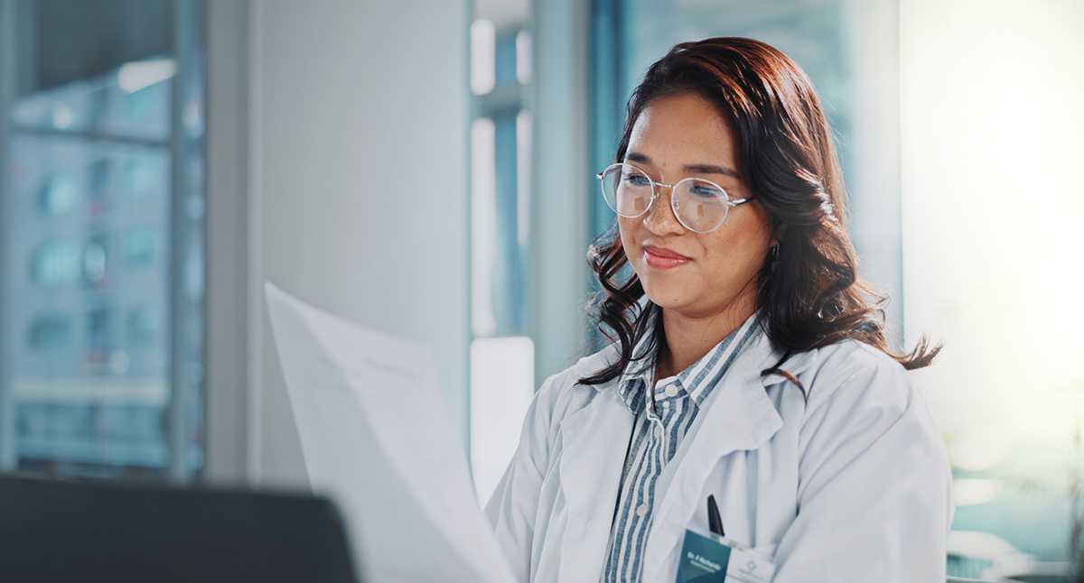 trusted knowledge image of a woman smiling while reading
