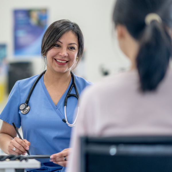 Female nurse consulting with a female patient.